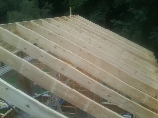 New roof rafters set over an addition before sheathing in Steinhatchee
